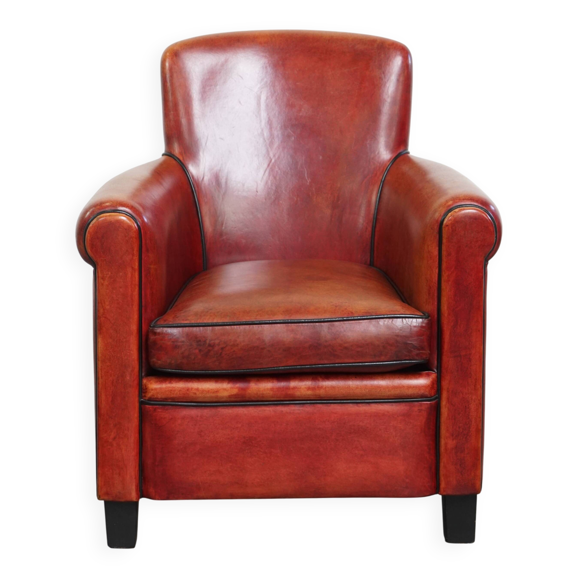 Armchair made of sheepskin leather in a red/brown color