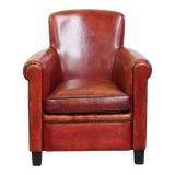 Armchair made of sheepskin leather in a red/brown color