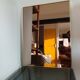 Vintage mirror in gilded brass and smoked glass. circa 1970