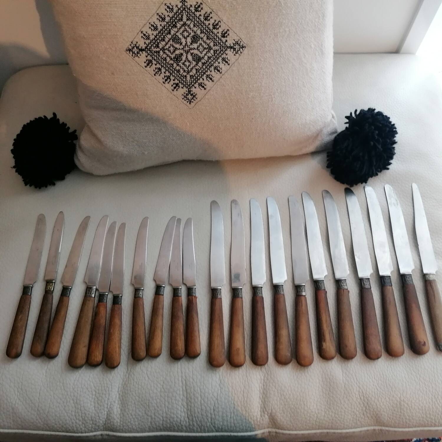 Old table knives and dessert knives, wooden handles, stainless steel blades