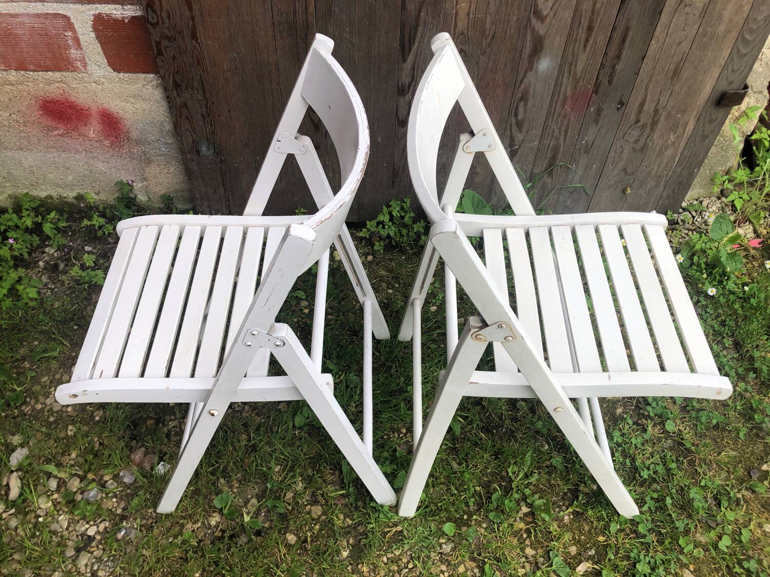 Pair of vintage white wooden folding chairs