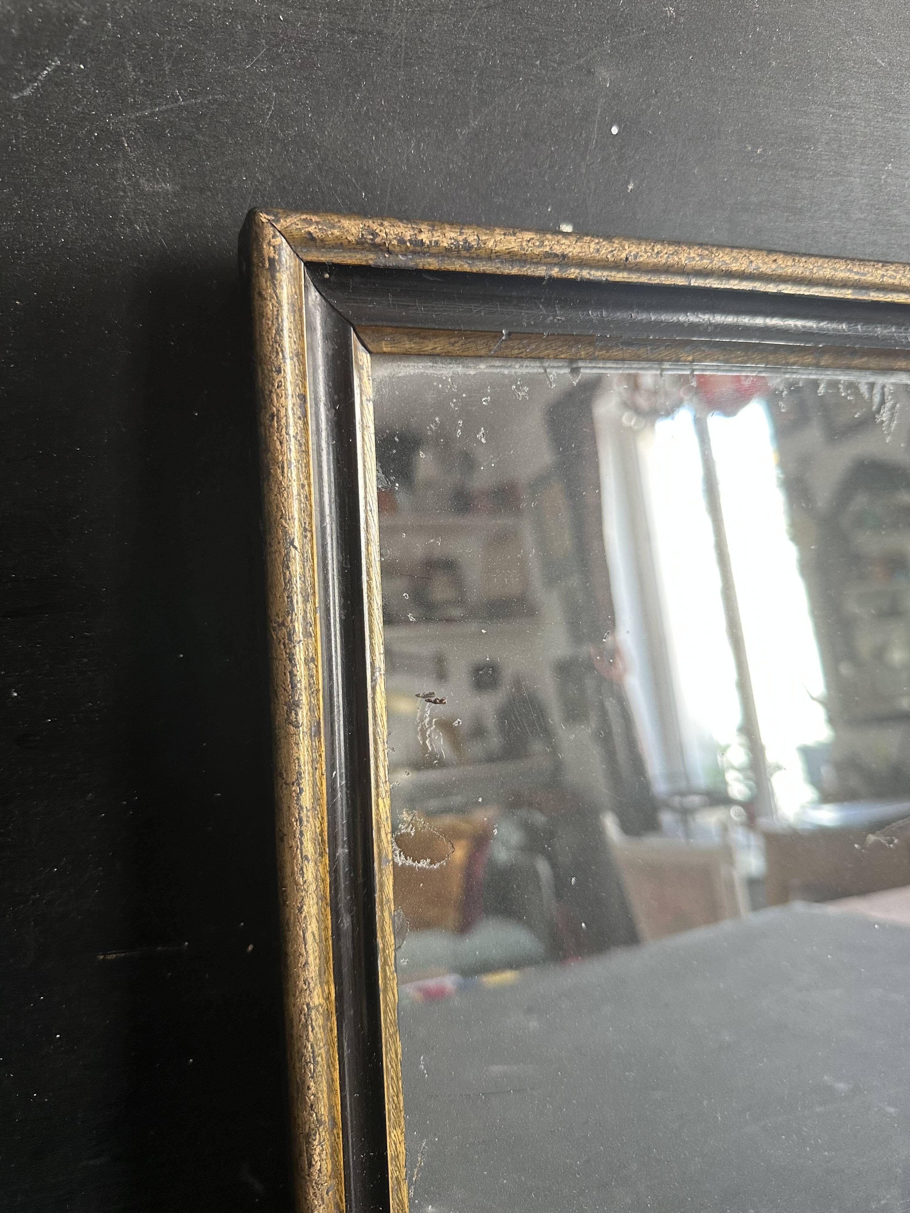 Miroir Napoléon III en bois noir et doré, XIXe siècle