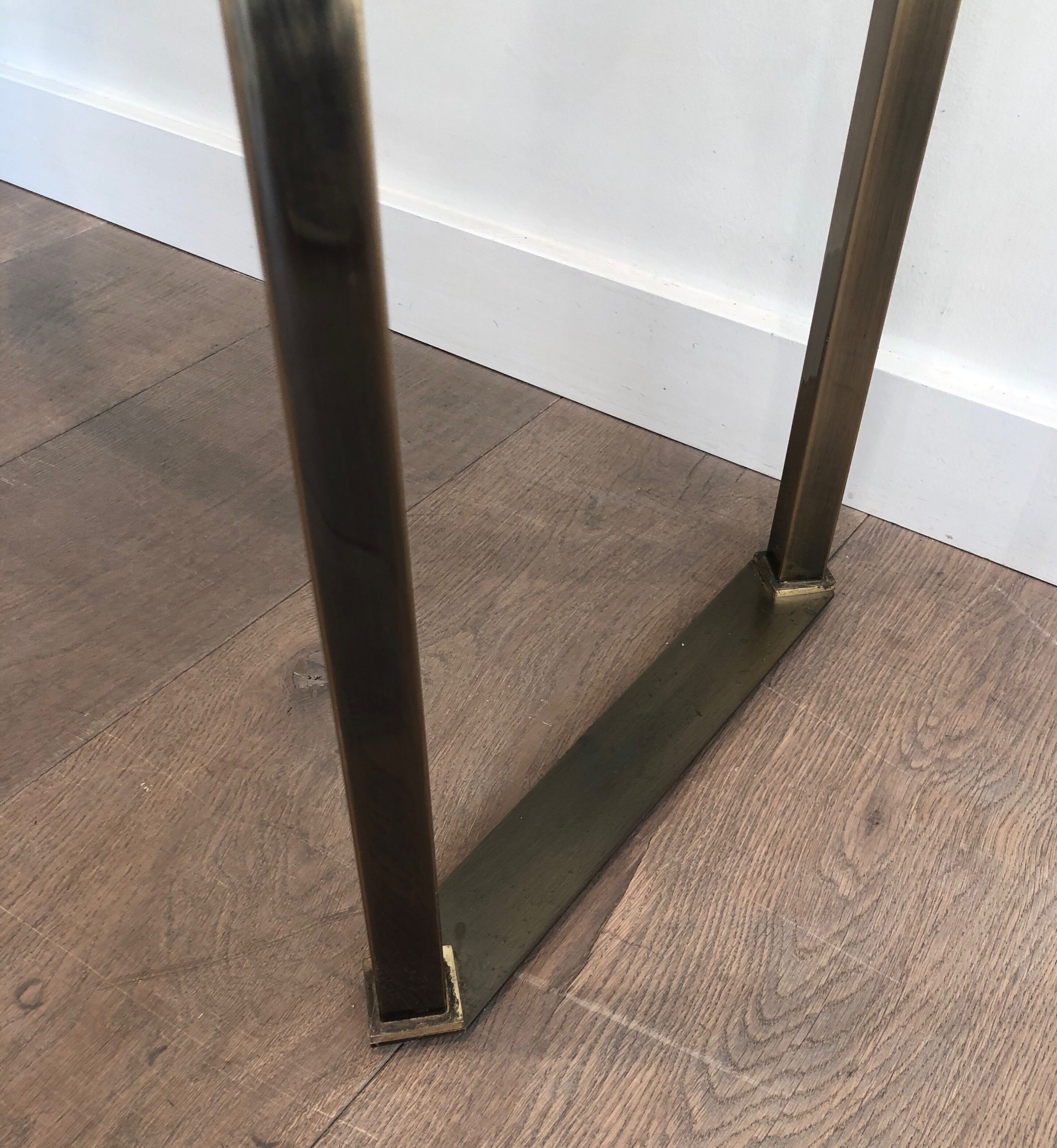 Console in brushed steel and brass and tray formed of a glass slab. French work. Around 1970