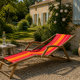 Vintage deck chair with red and orange striped fabric, original patina.