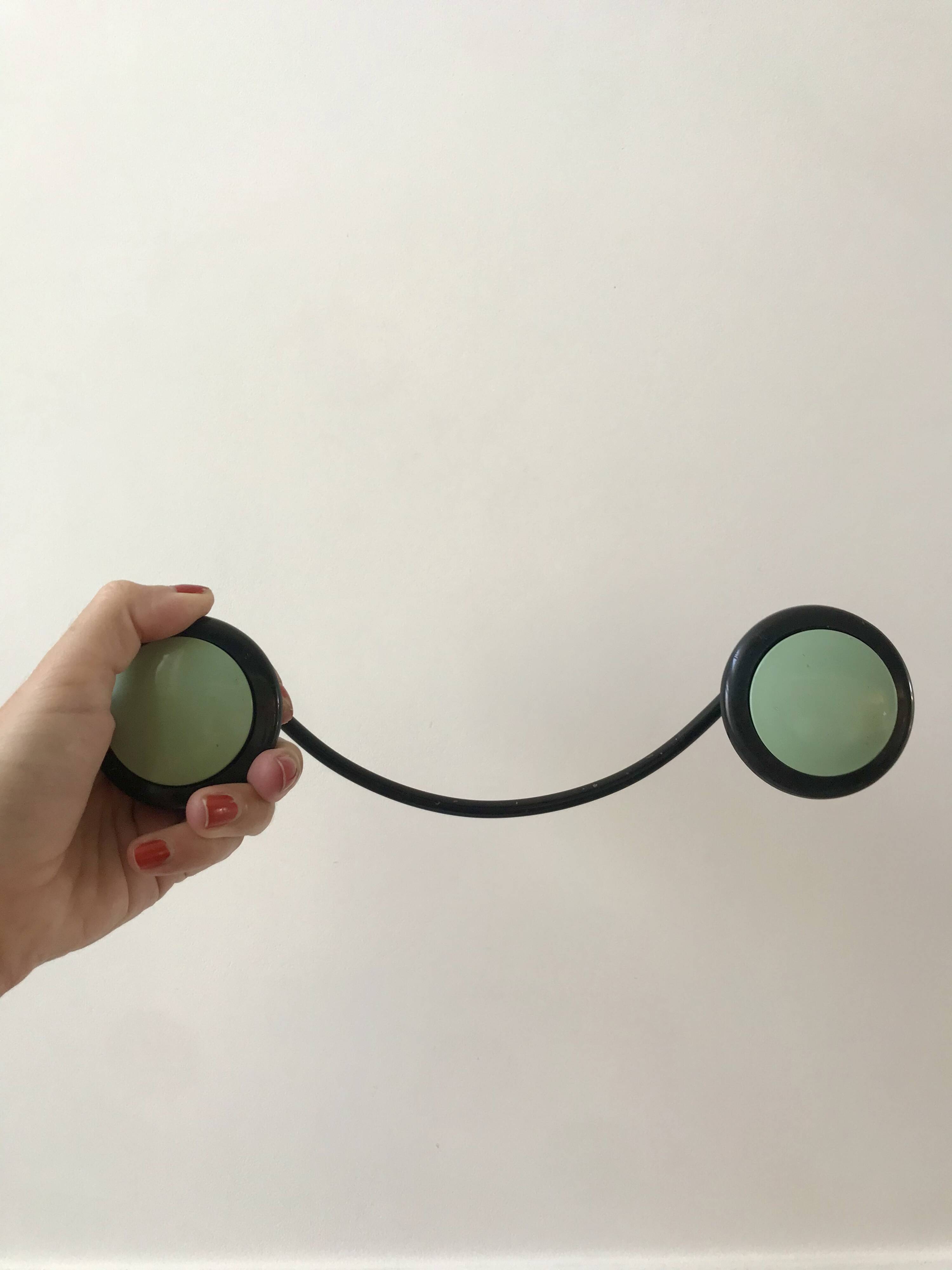 Design coat hook in sage green and black metal from the 70s