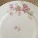 Flat old plates mismatched with flowers