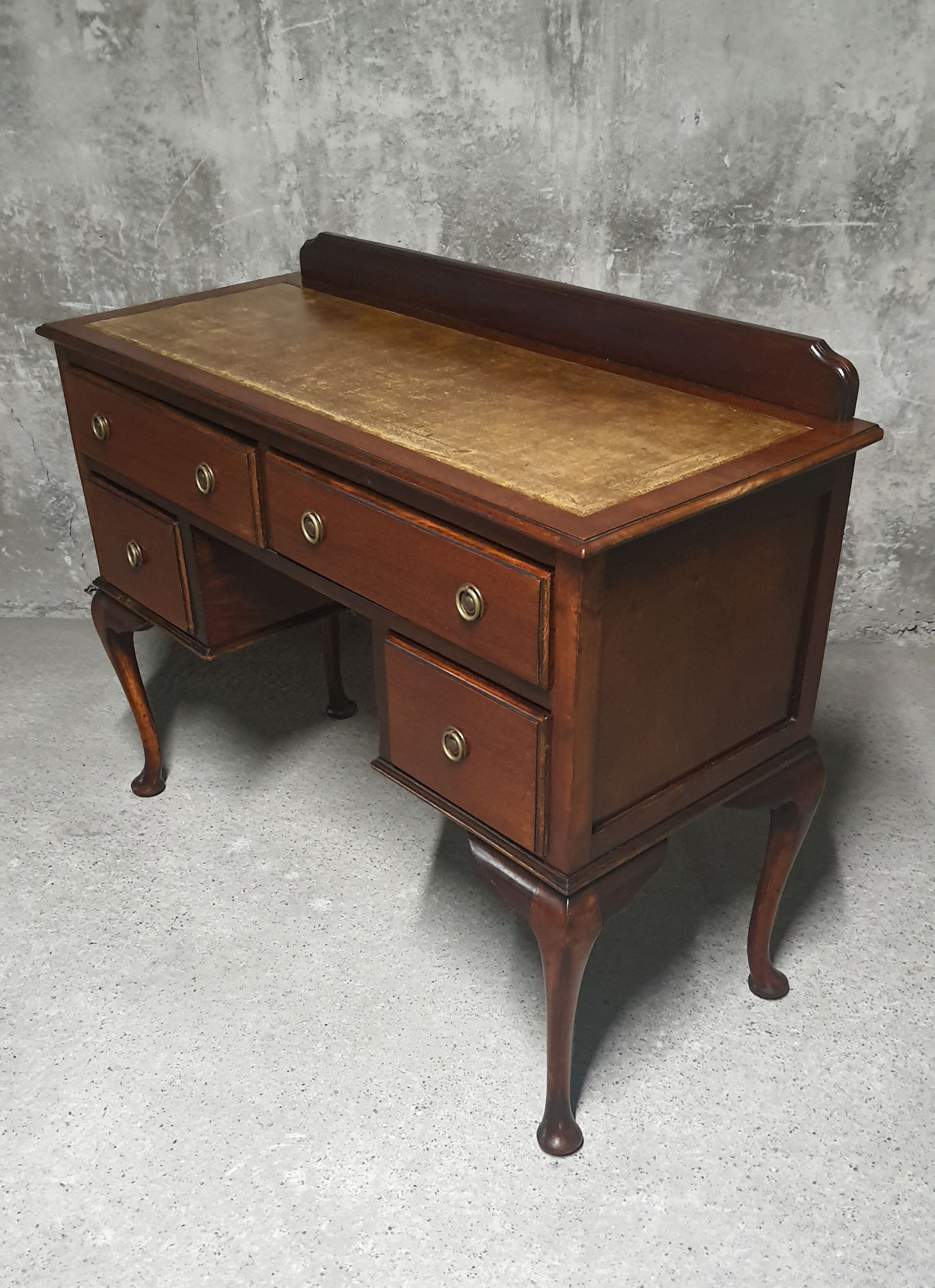 Old desk in cherry and green leather