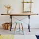 Antique tripod stool with striped seat.