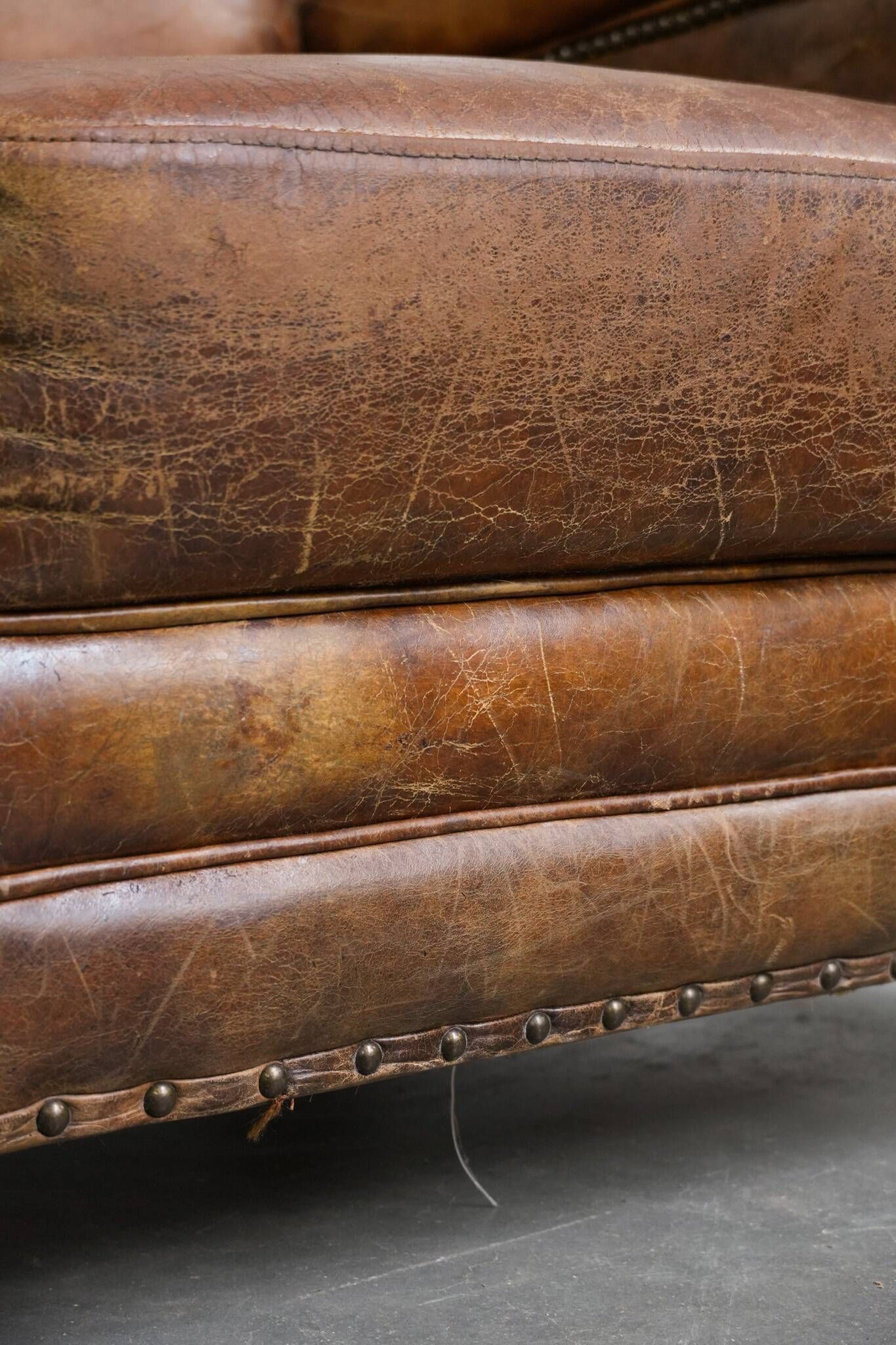 Charming and comfortable vintage armchair in grained cowhide leather with character
