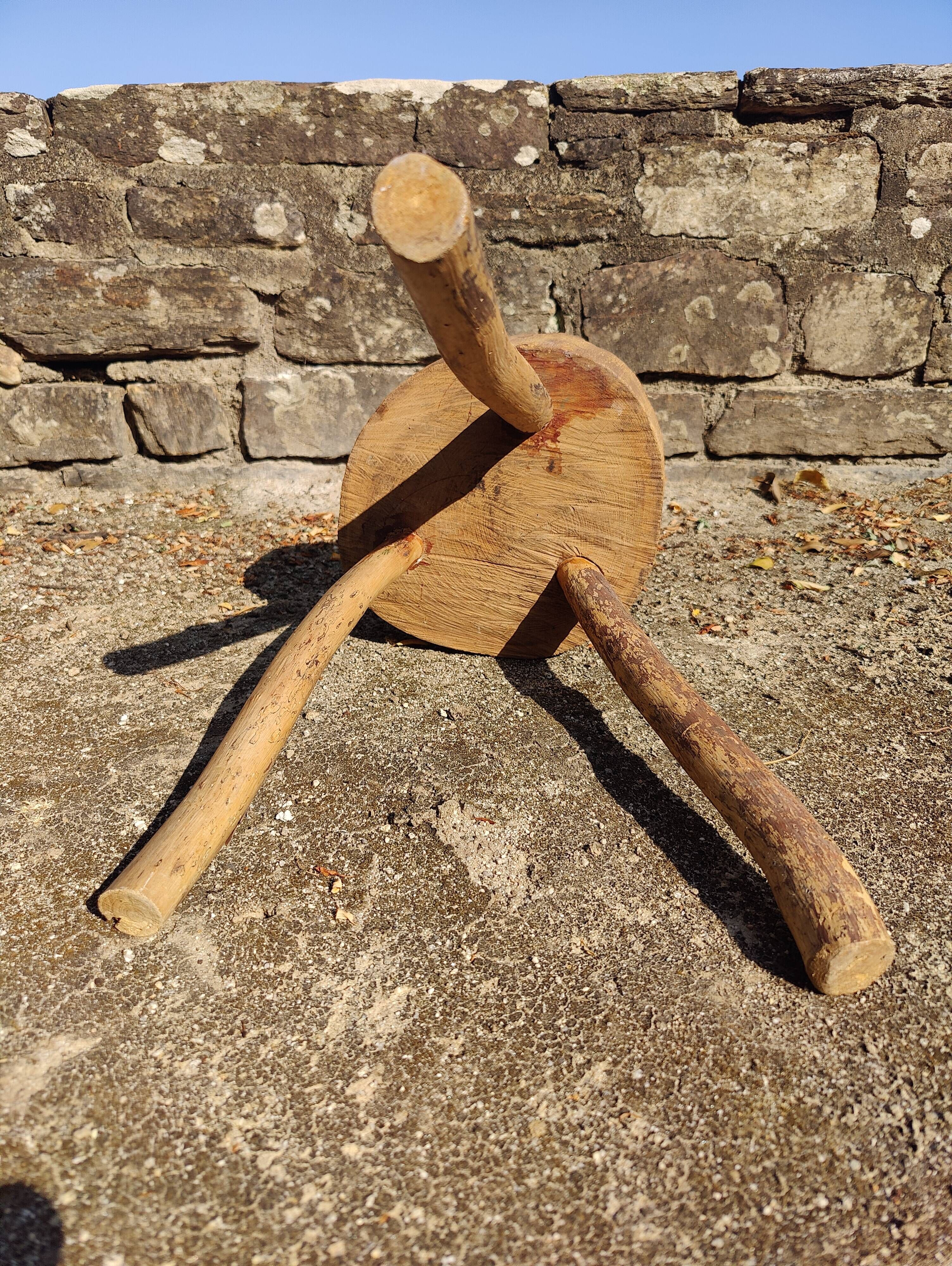 Rustic three-legged stool in minimalist wood in the style of Touret.