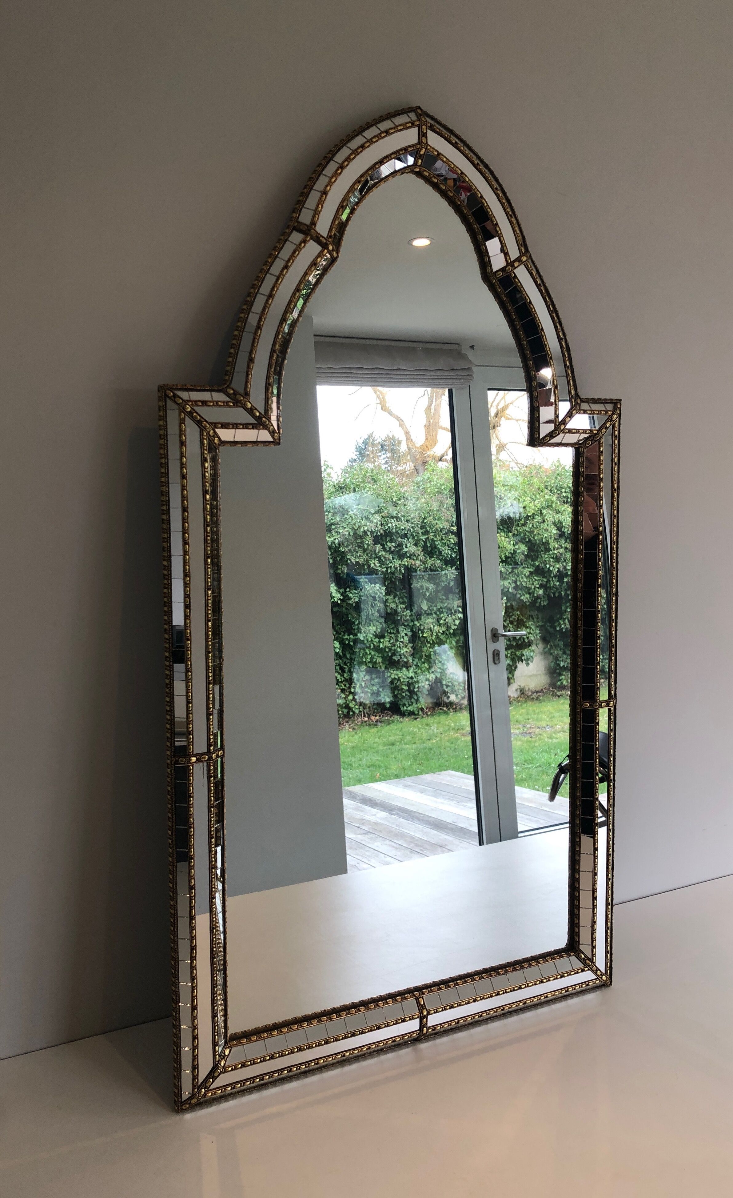 Mirror consisting of multi-faceted mirrors and brass garlands, French work, around 1970