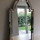 Mirror consisting of multi-faceted mirrors and brass garlands, French work, around 1970