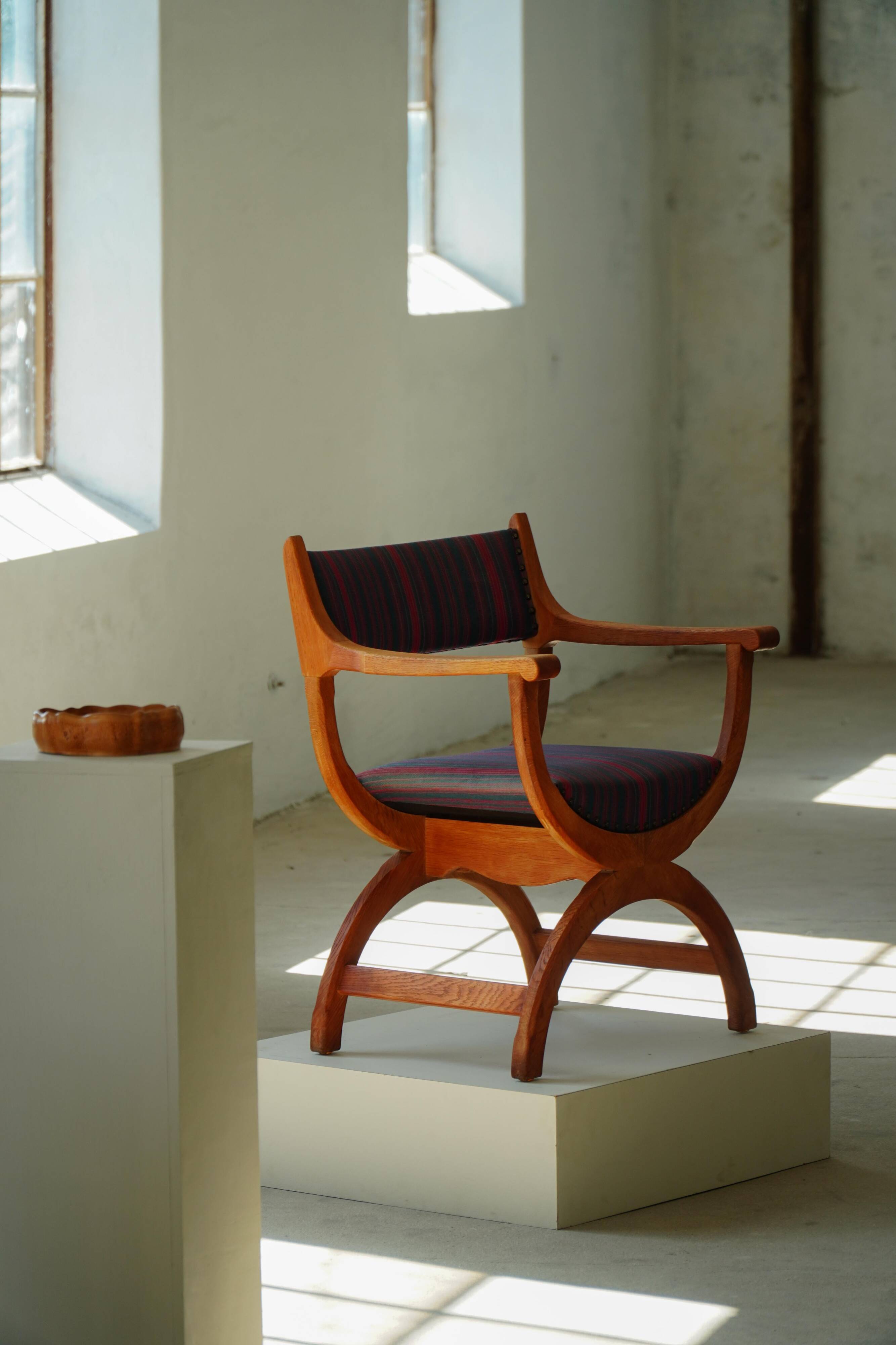 Henning Kjærnulf, pair of oak armchairs, model "Kurul", Danish modern style, 1960s.