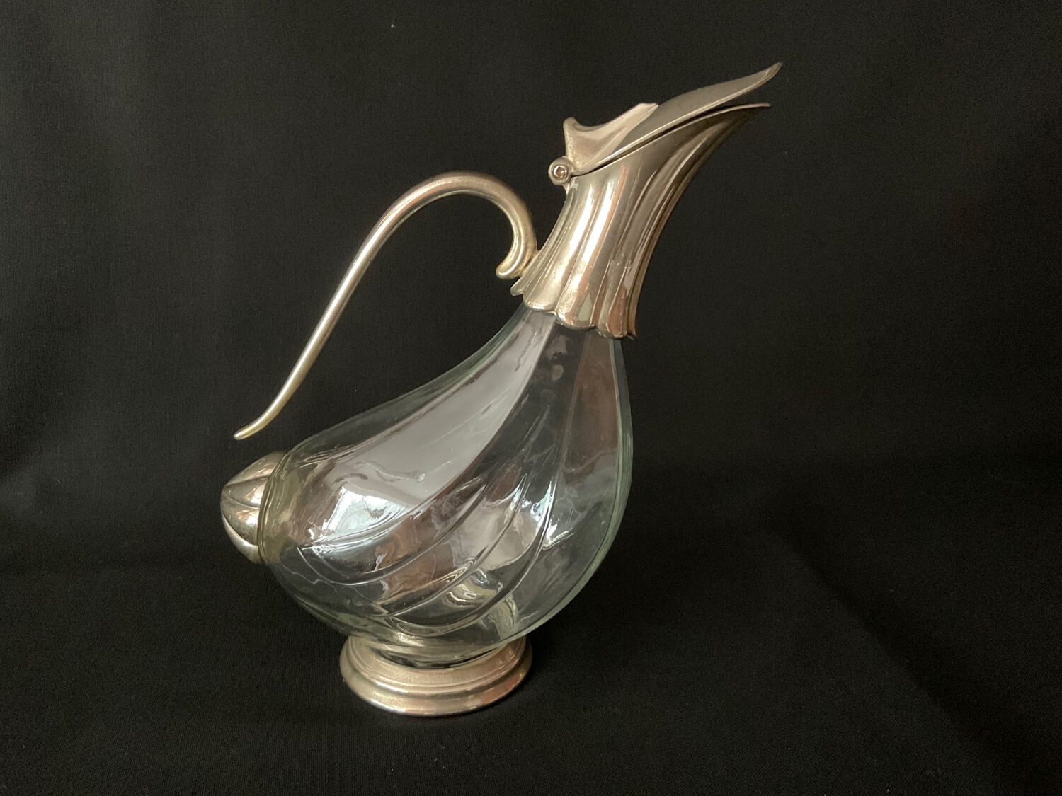 Glass decanter and silver metal duck