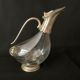 Glass decanter and silver metal duck