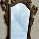 Carved and gilded wooden wall mirror.
