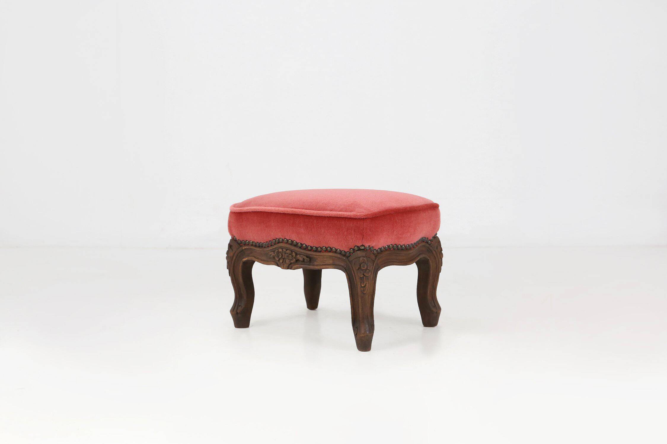 Baroque style foot stool in carved wood with coral velvet upholstery