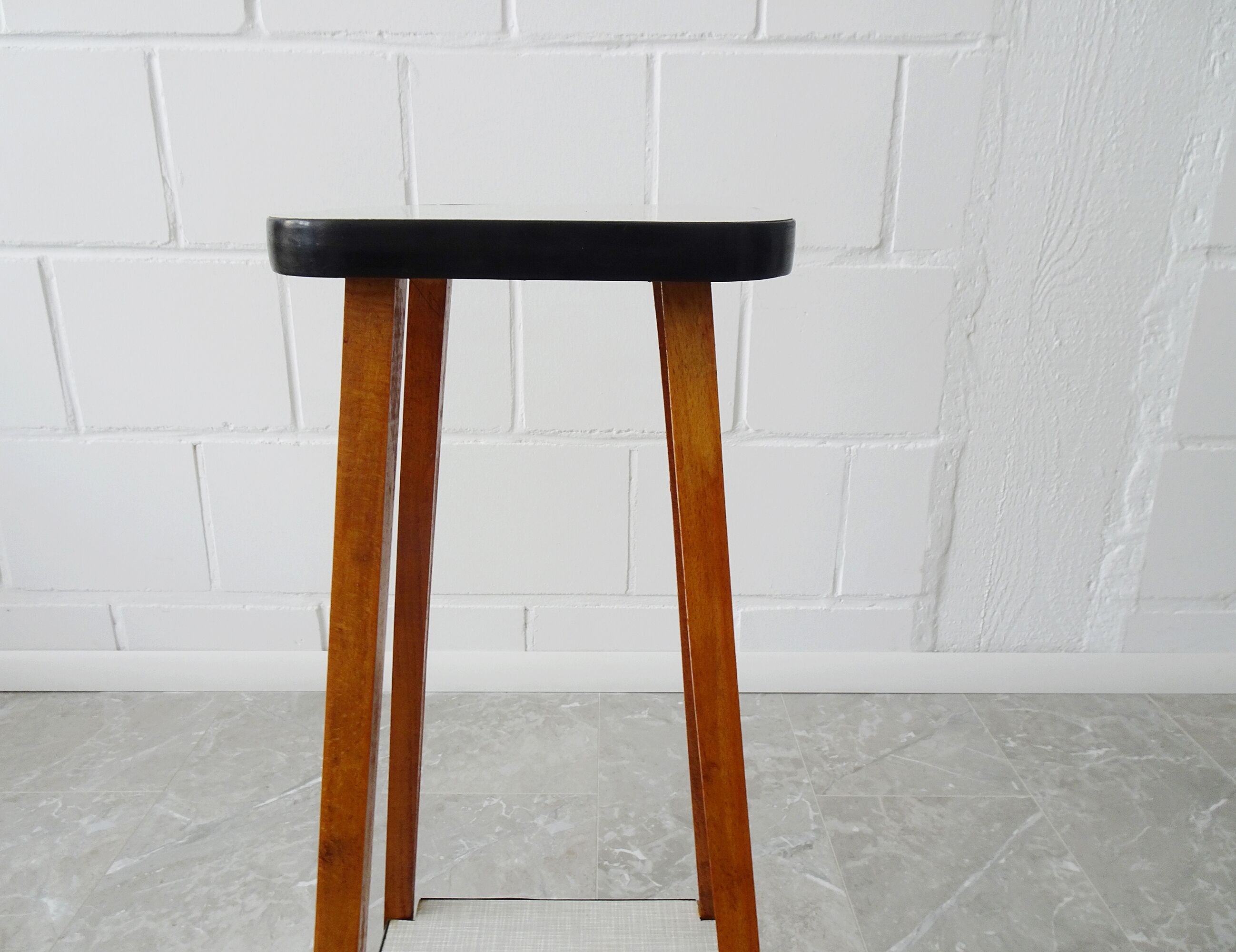 Plant stand made of wood and formica with two shelves, flower column