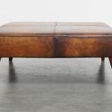 Hocker/coffee table made of sheepskin