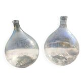 Set of 2 antique glass demijohns.