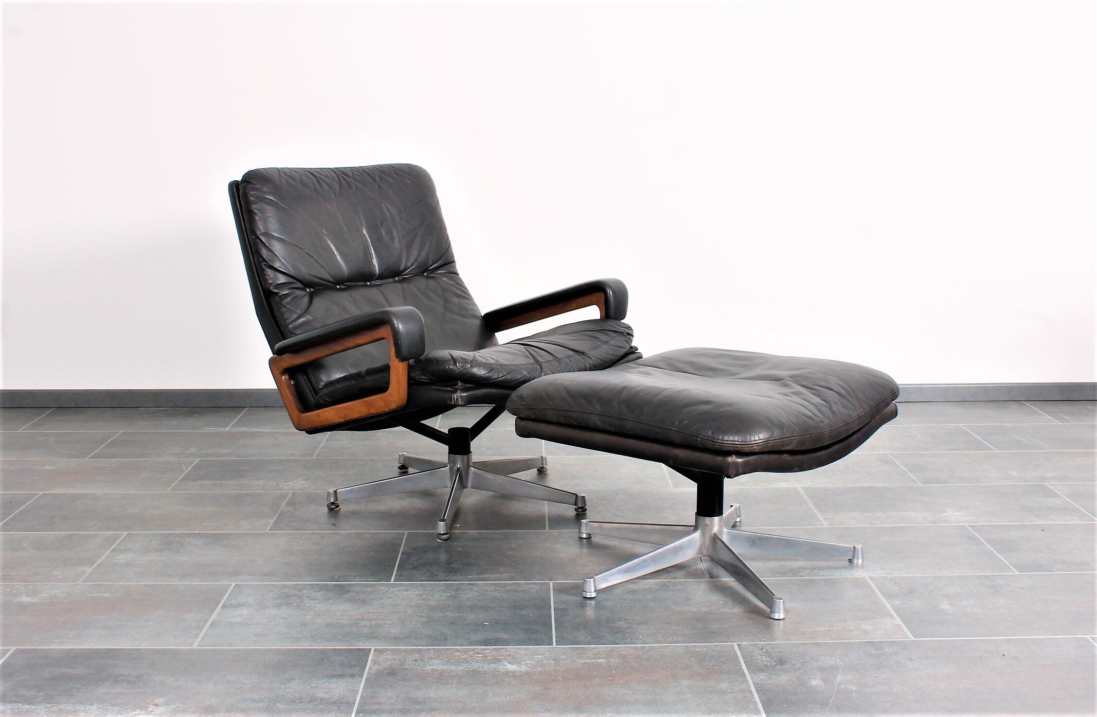 Armchair and footstool by André Vandenbeuck for Strässle in black leather