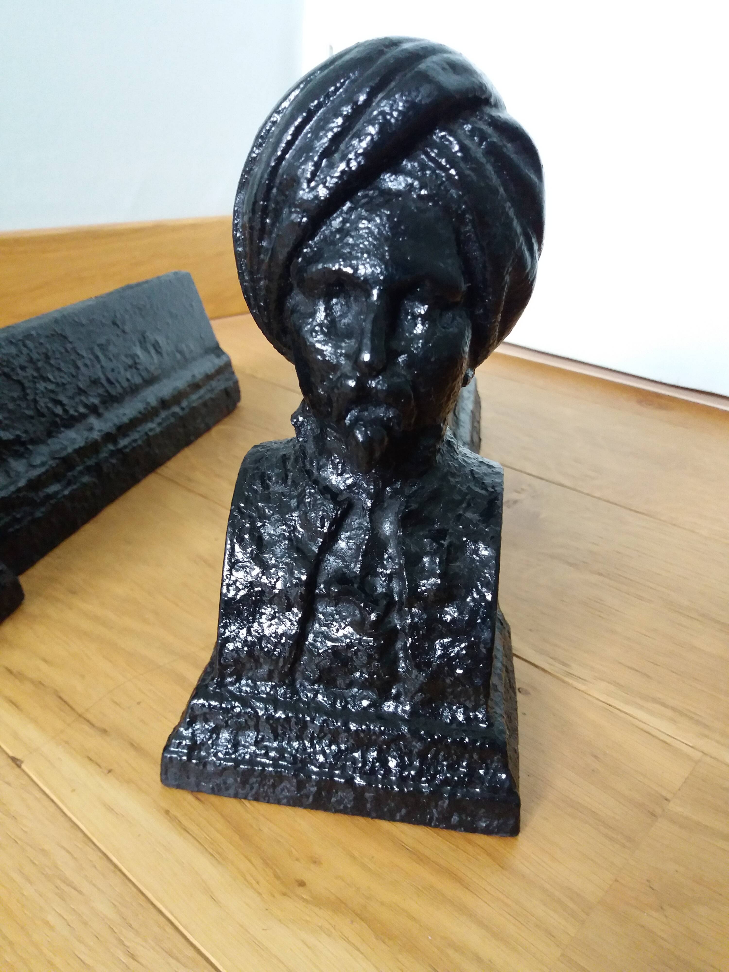 Cast iron andirons with character heads