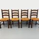 Set of 4 vintage brutalist chairs by Georges Robert in wood and straw.