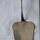 Silver metal cake peeler.