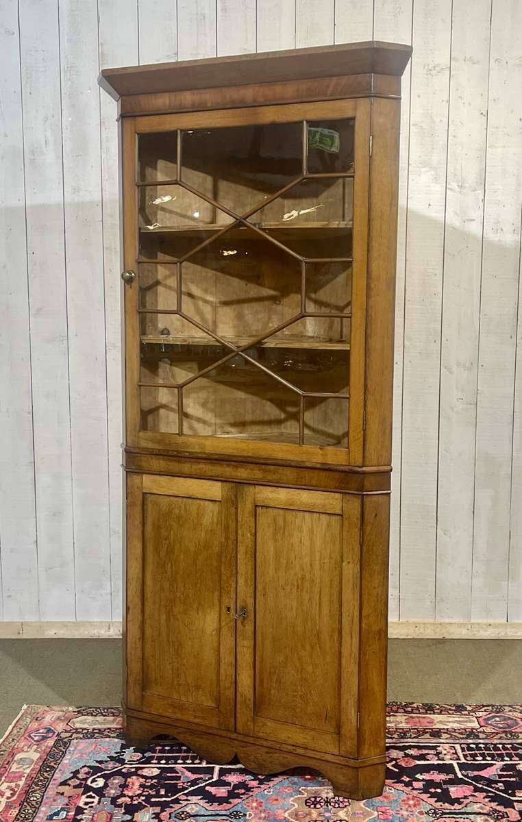 19th-century English corner cabinet in oak, mahogany, and fir.