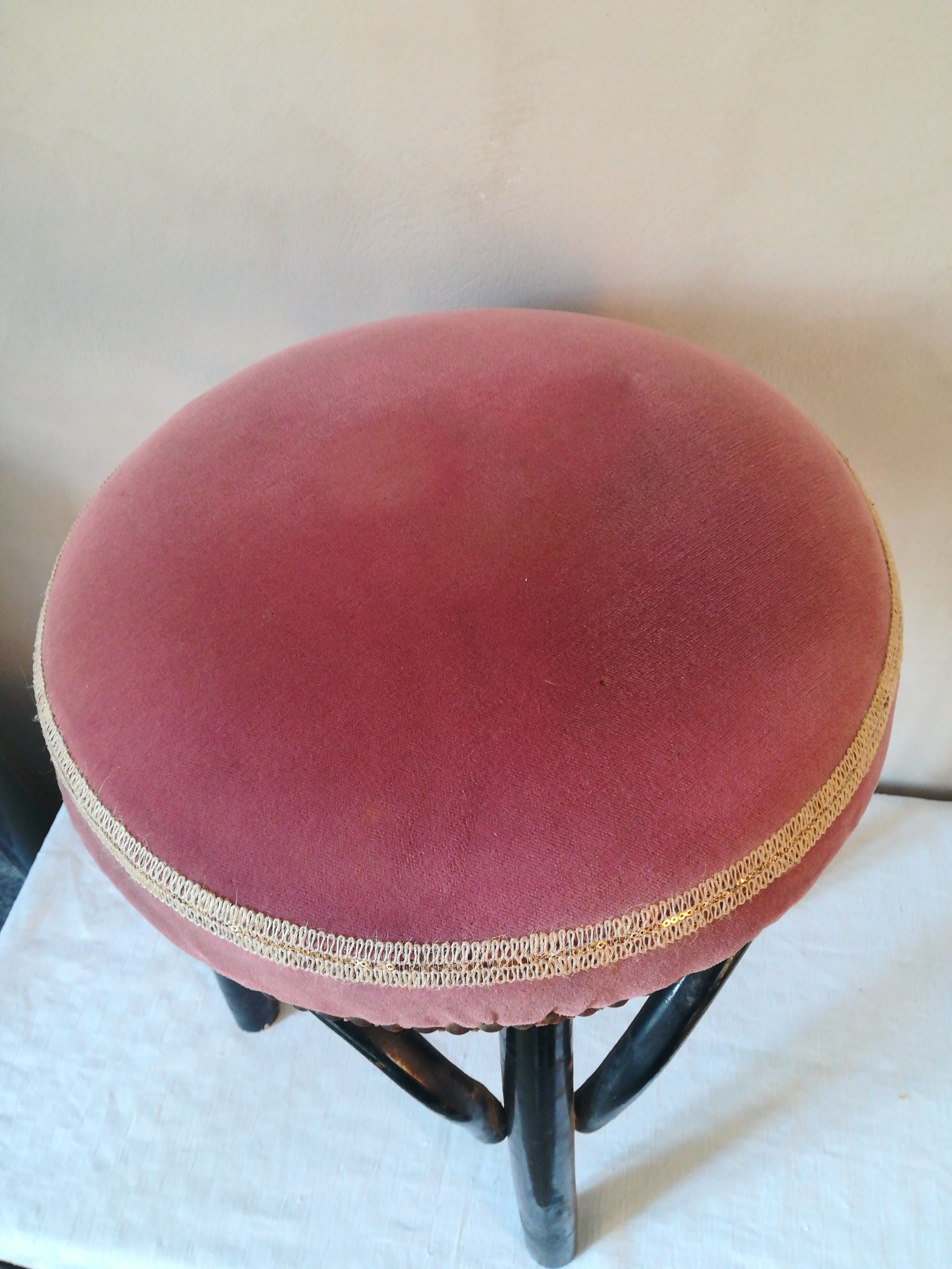 Black stool sitting in velvet rose