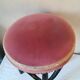 Black stool sitting in velvet rose