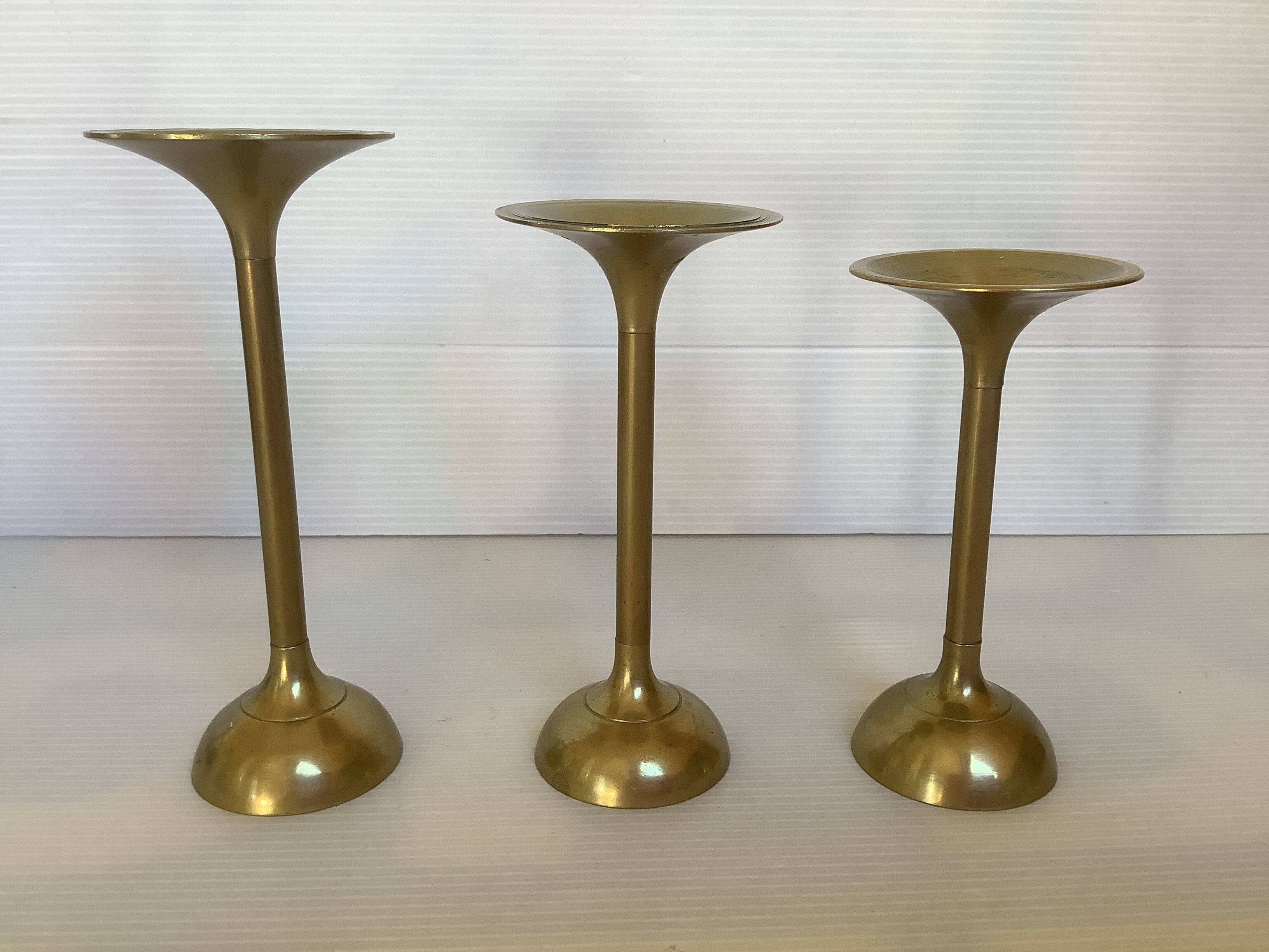 Trio of brass tulip foot candle holders