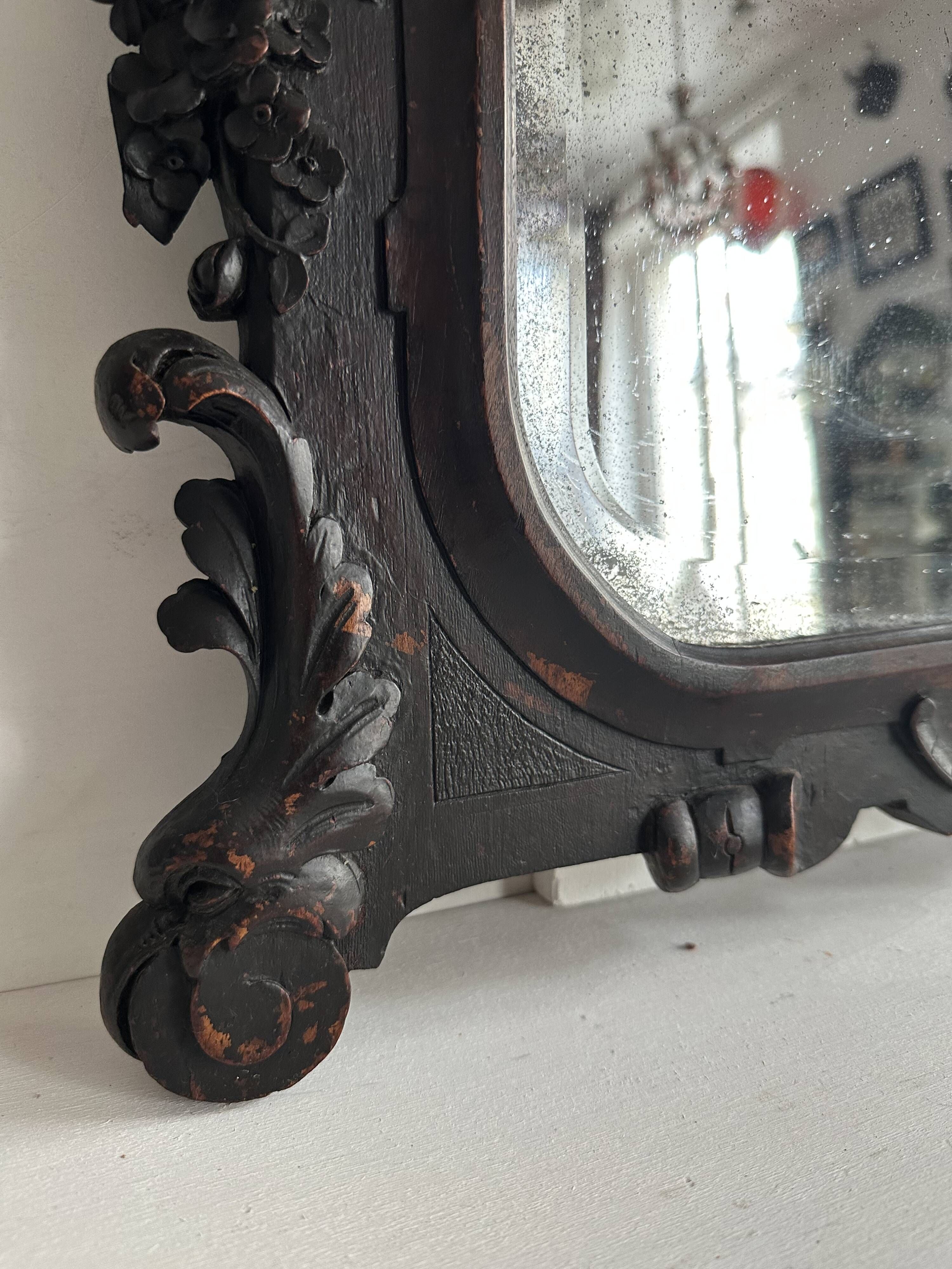 Napoleon III mirror in carved blackened wood, 19th century