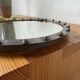 Brutalist round mirror with wrought iron and studs.