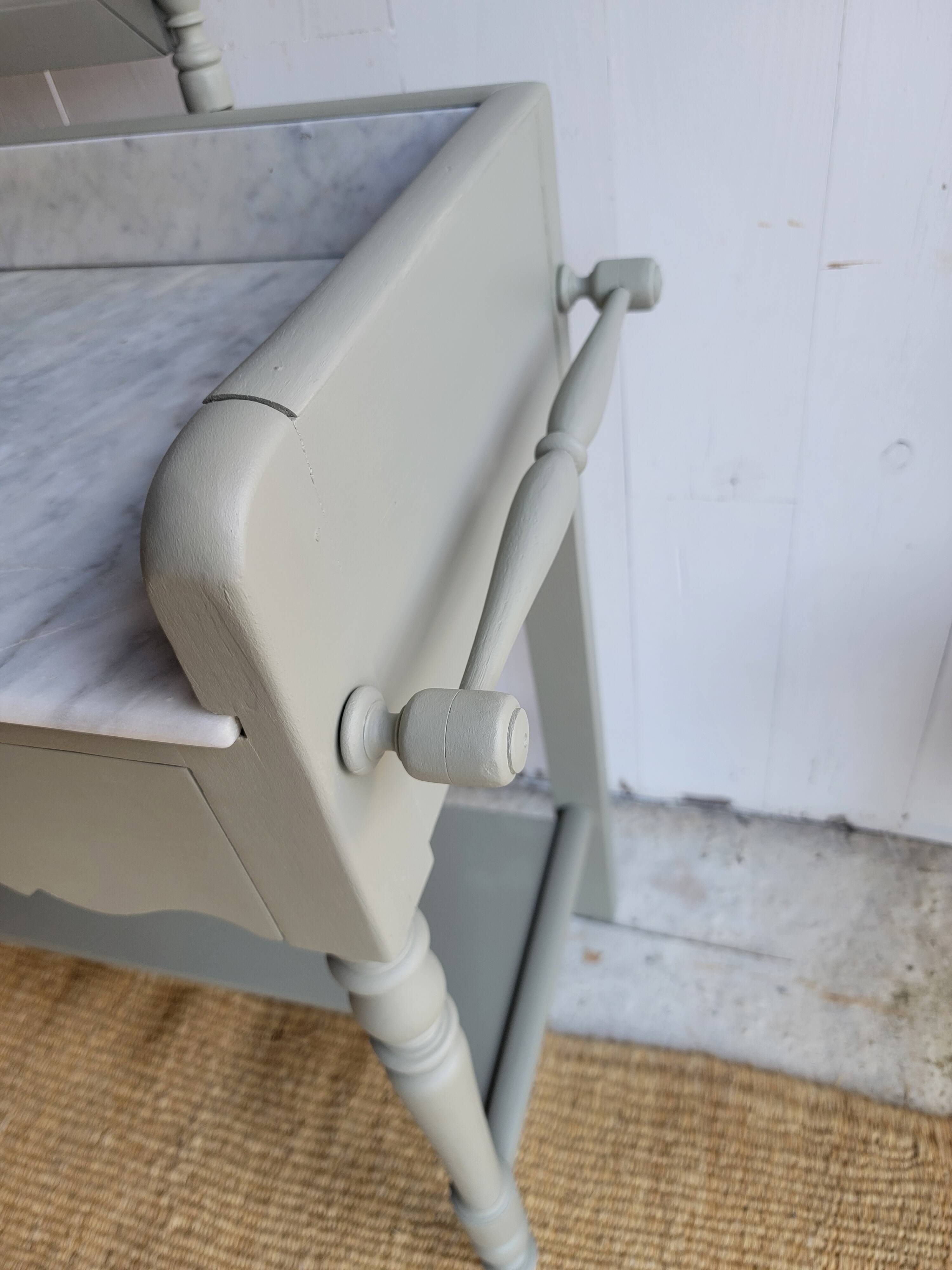 Antique wooden dressing table with marble top and mirror.