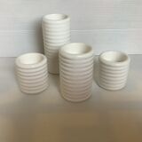 Four white earthenware candle holders