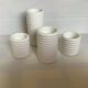 Four white earthenware candle holders