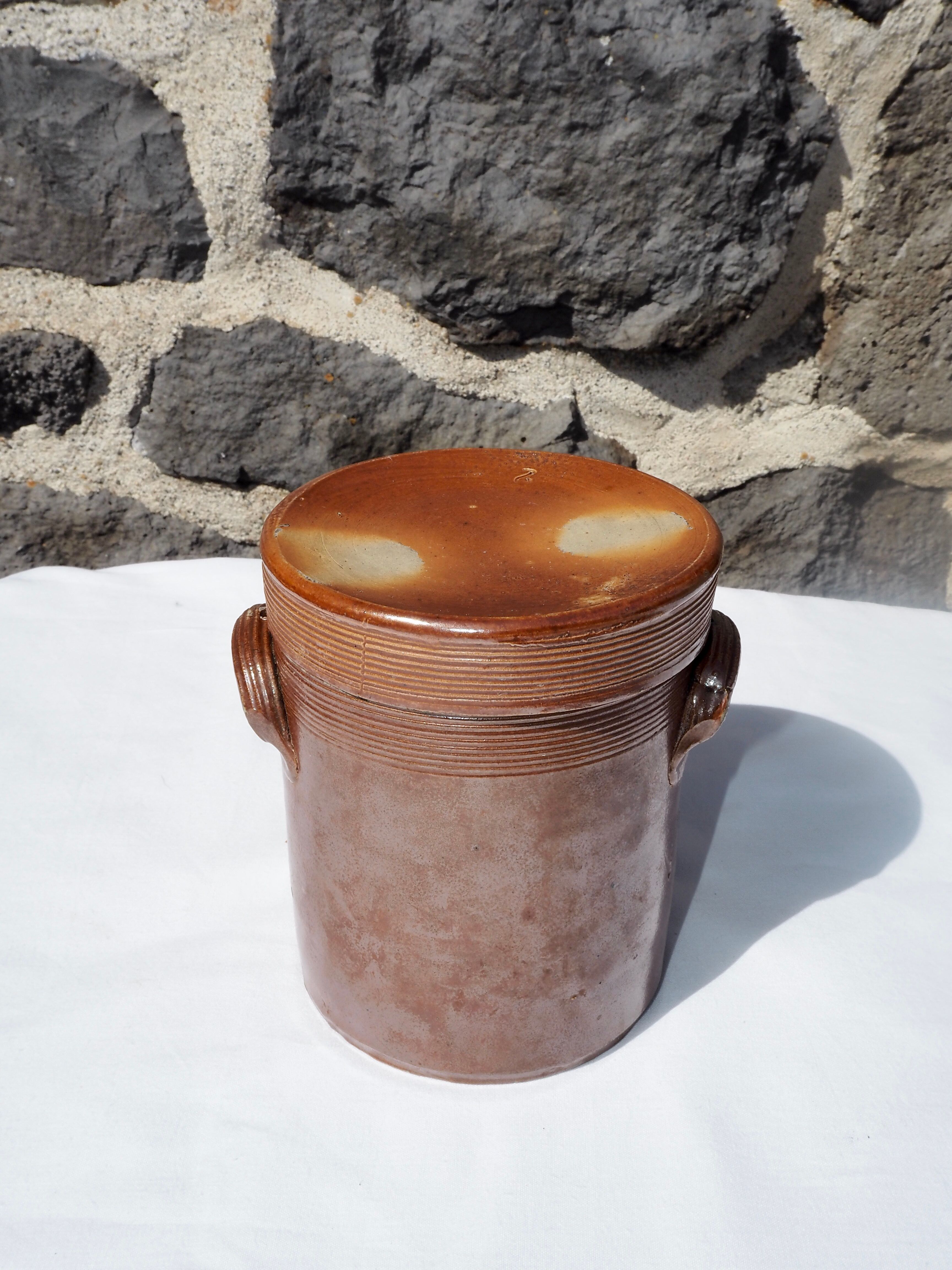 Trio of stoneware pots with lids