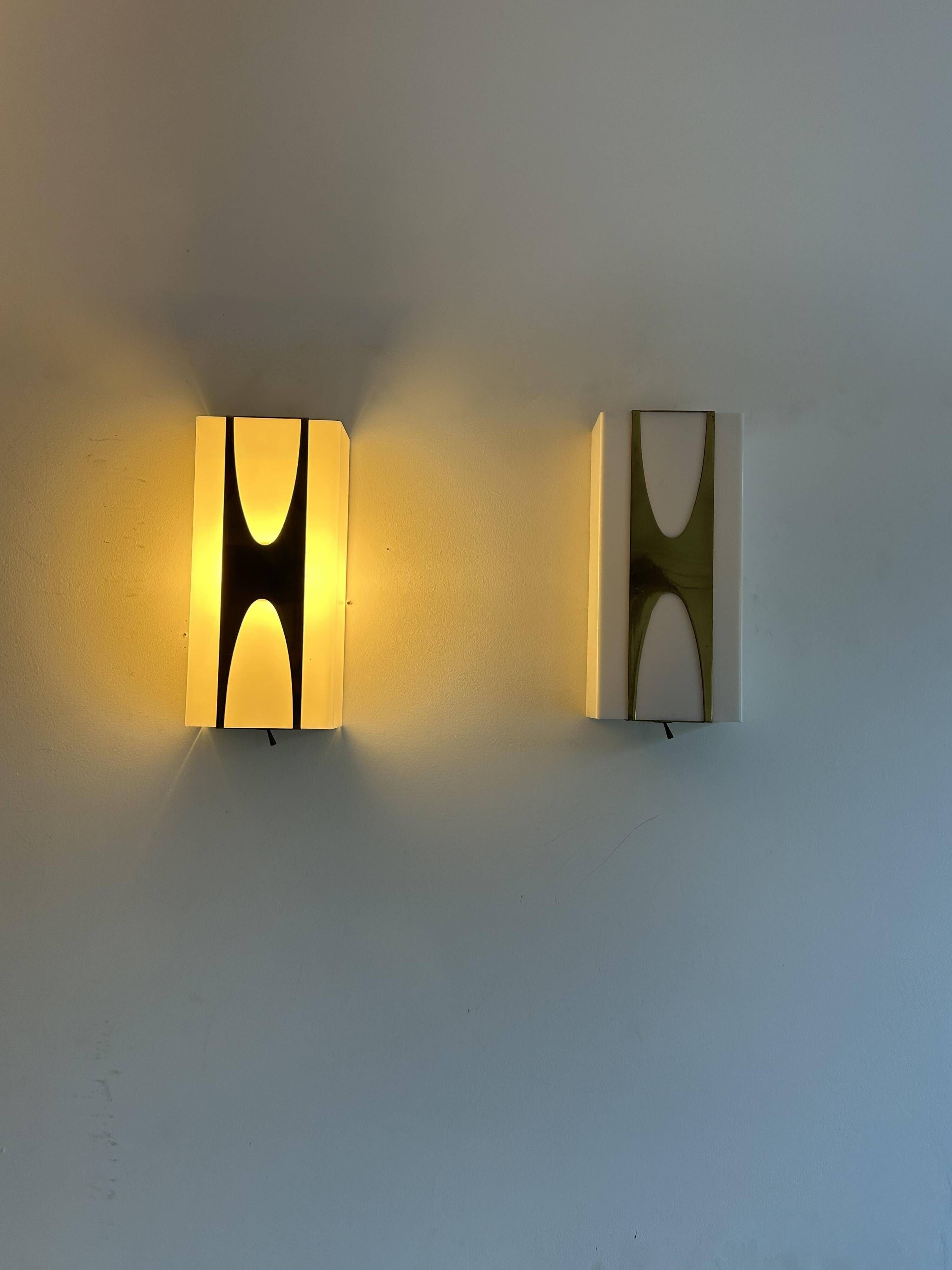 Pair of Loewy wall lights for Hilton, brass and Perspex, France 1965