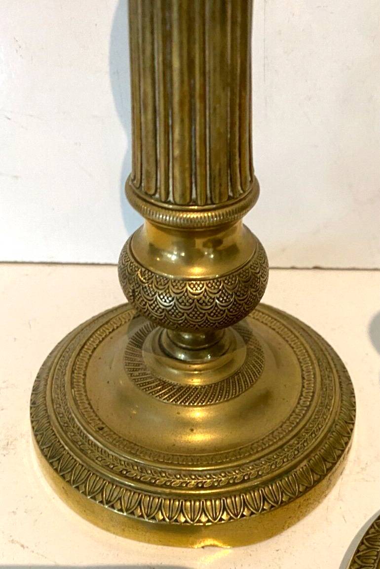 Pair of Louis XVI style candlesticks in 19th century chiseled bronze