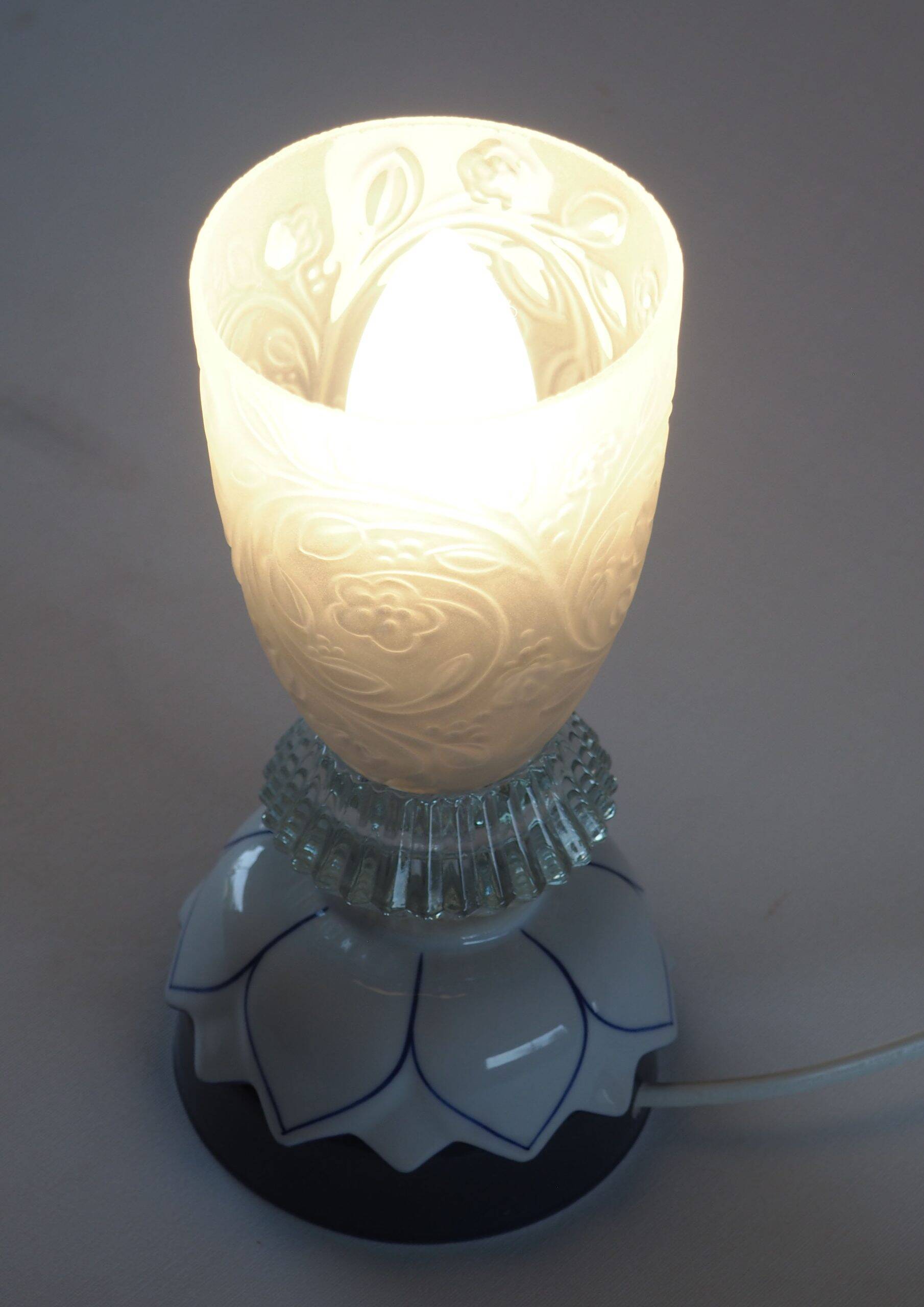 Glass lamp with floral relief in blue lotus design.