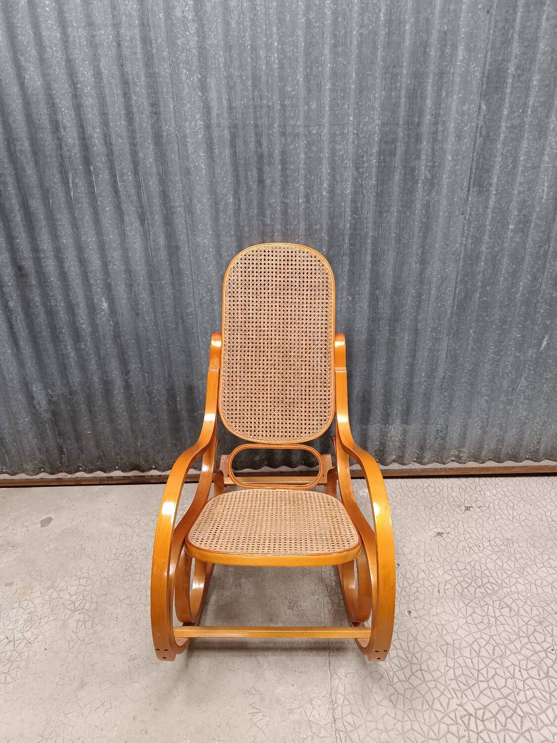 Rocking chair made of bent wood and rattan wicker.