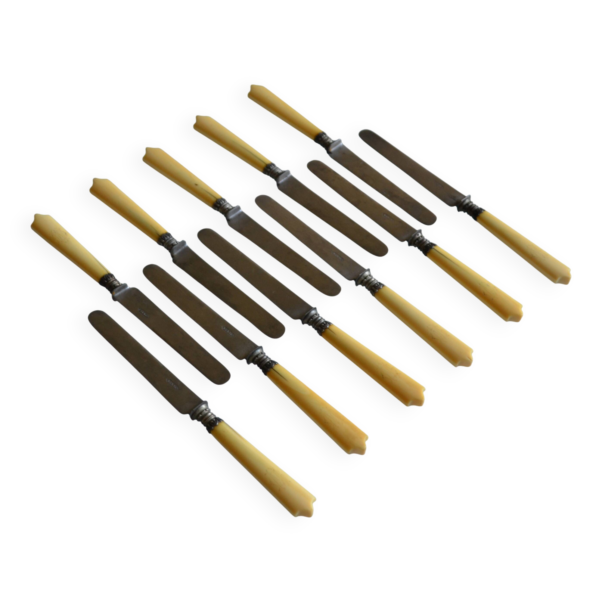 11 antique 19th-century table knives with ivory-colored monogram handles