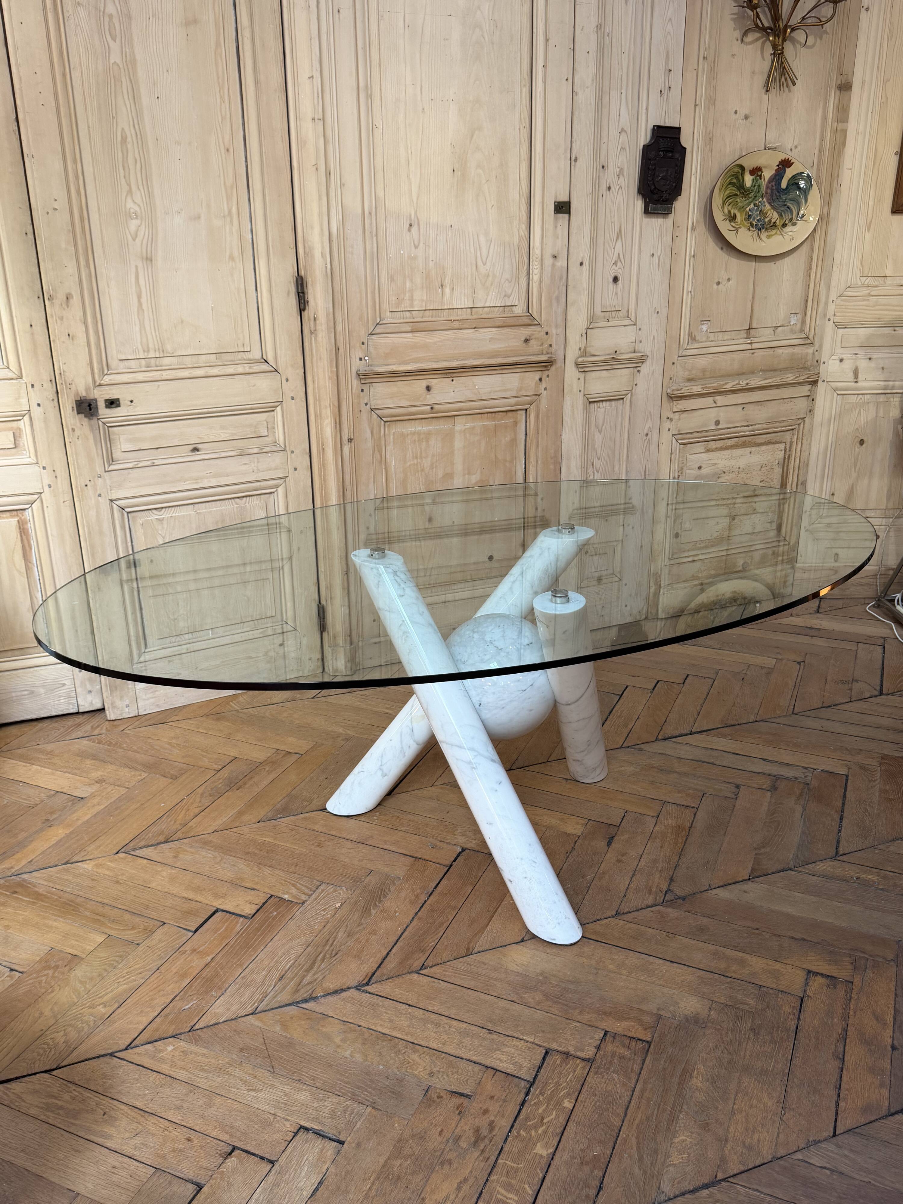 Dining table with glass top and marble base, Ligne Roset.