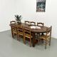 Set of 8 chairs in solid elm with straw seats.