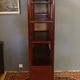 Low sideboard surmounted by bibus shelves in red lacquered wood, China XXth, 120 x 195 cm