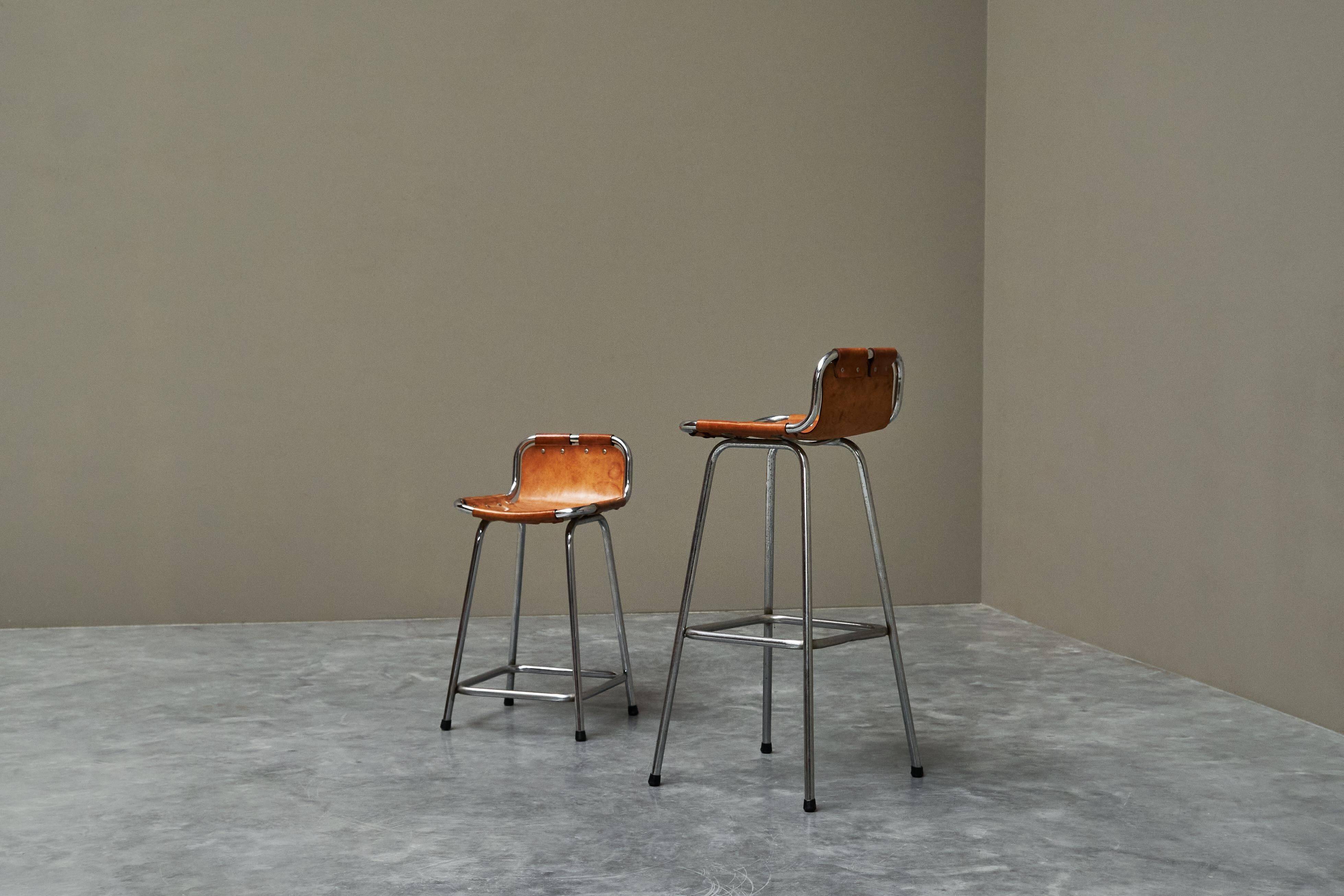 Set of 2 stools "Les Arcs" selected by Charlotte Perriand in leather.