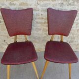Pair of wooden chairs and red skai, 50s