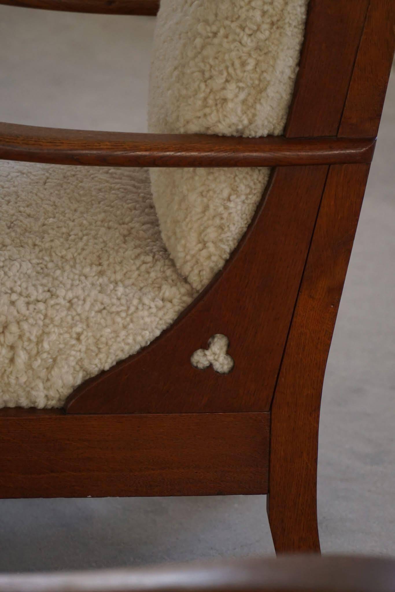 Modern Danish design, a pair of high-backed armchairs in oak and lambswool, 1950s.