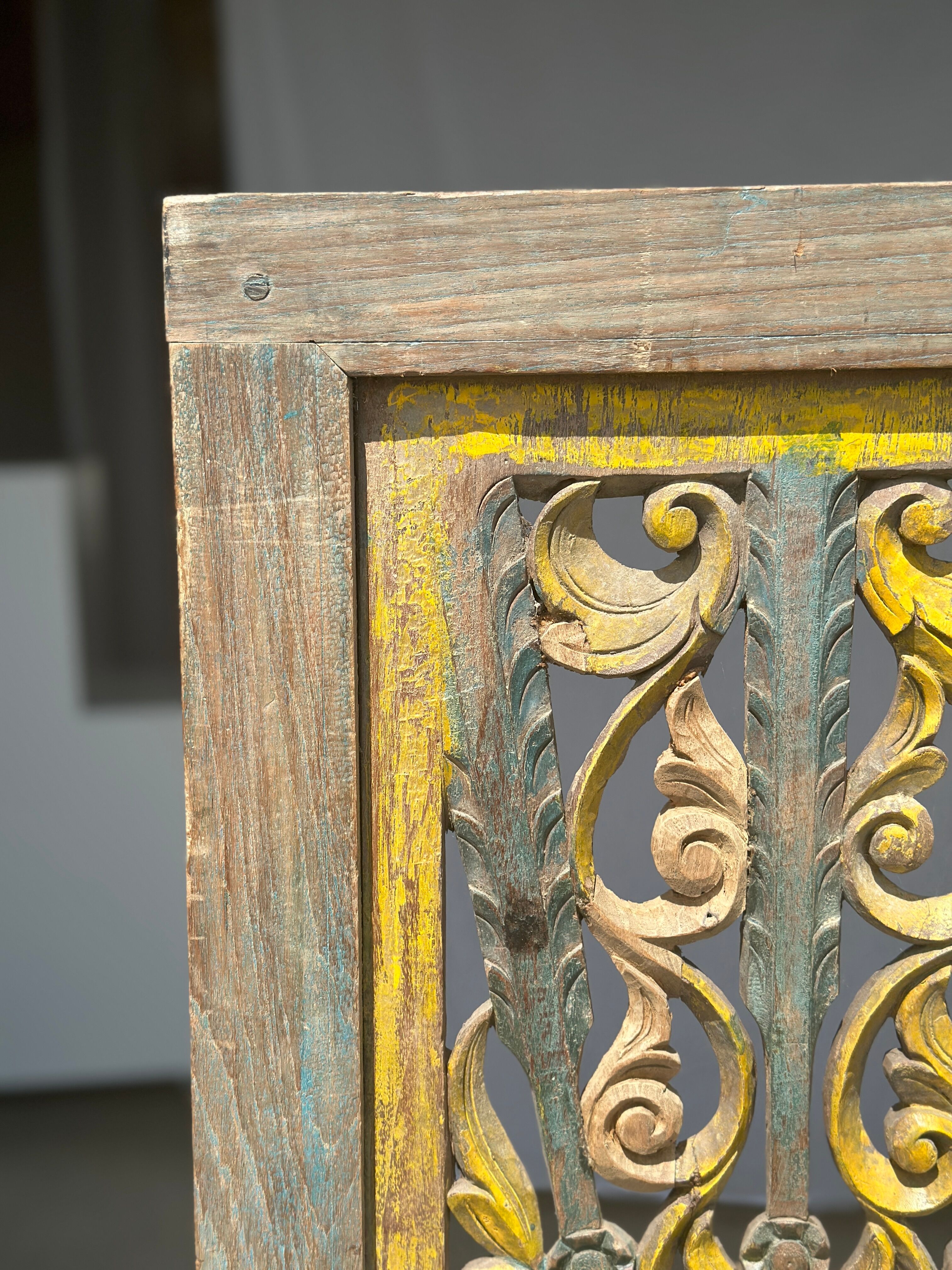 Rectangular Indonesian construction element with blue and yellow plant in carved wood